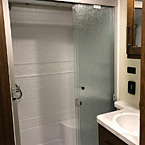 The Crusader Lite shower offers a triple pane glass door for a wider opening into your oversized RV shower