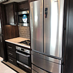 The 3202WB is sporting a 5th wheel kitchen you are sure to enjoy with the Furrion Chef Collection oven and stove top, 30 inch residential microwave and a 14.1 cubic foot refrigerator.