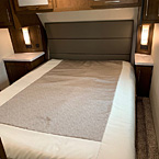 The full size queen bed (70” x 80”) is residential size and the bedroom features 6’ 5” of head room.